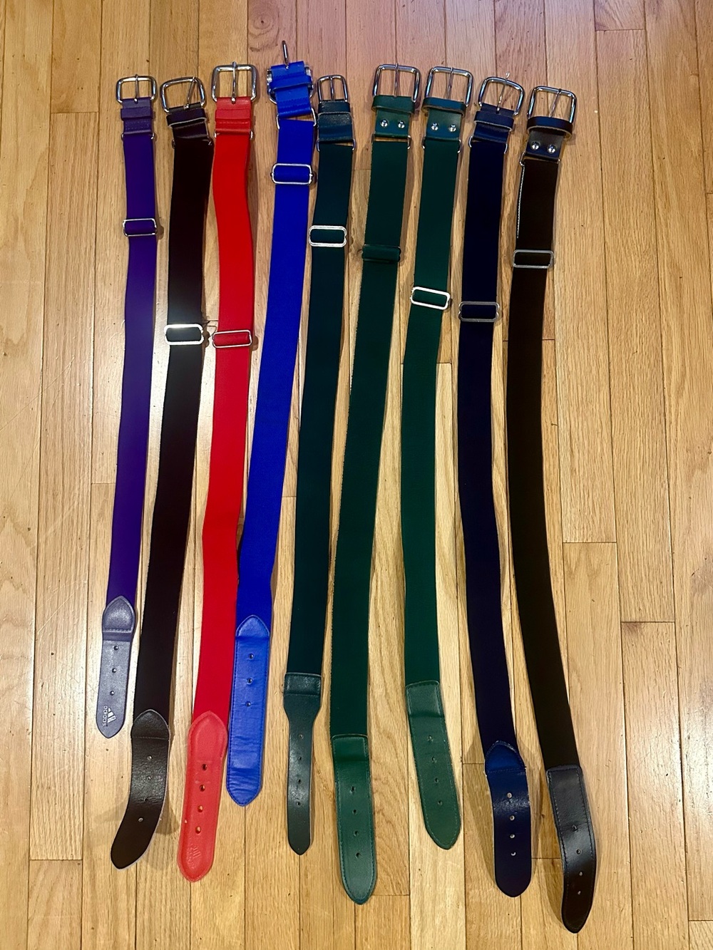 Nine Youth baseball belts. Various Colors. Purple, 3 black, 3 green, blue & red